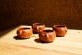 Juego de mezcaleros con cara de barro rojo