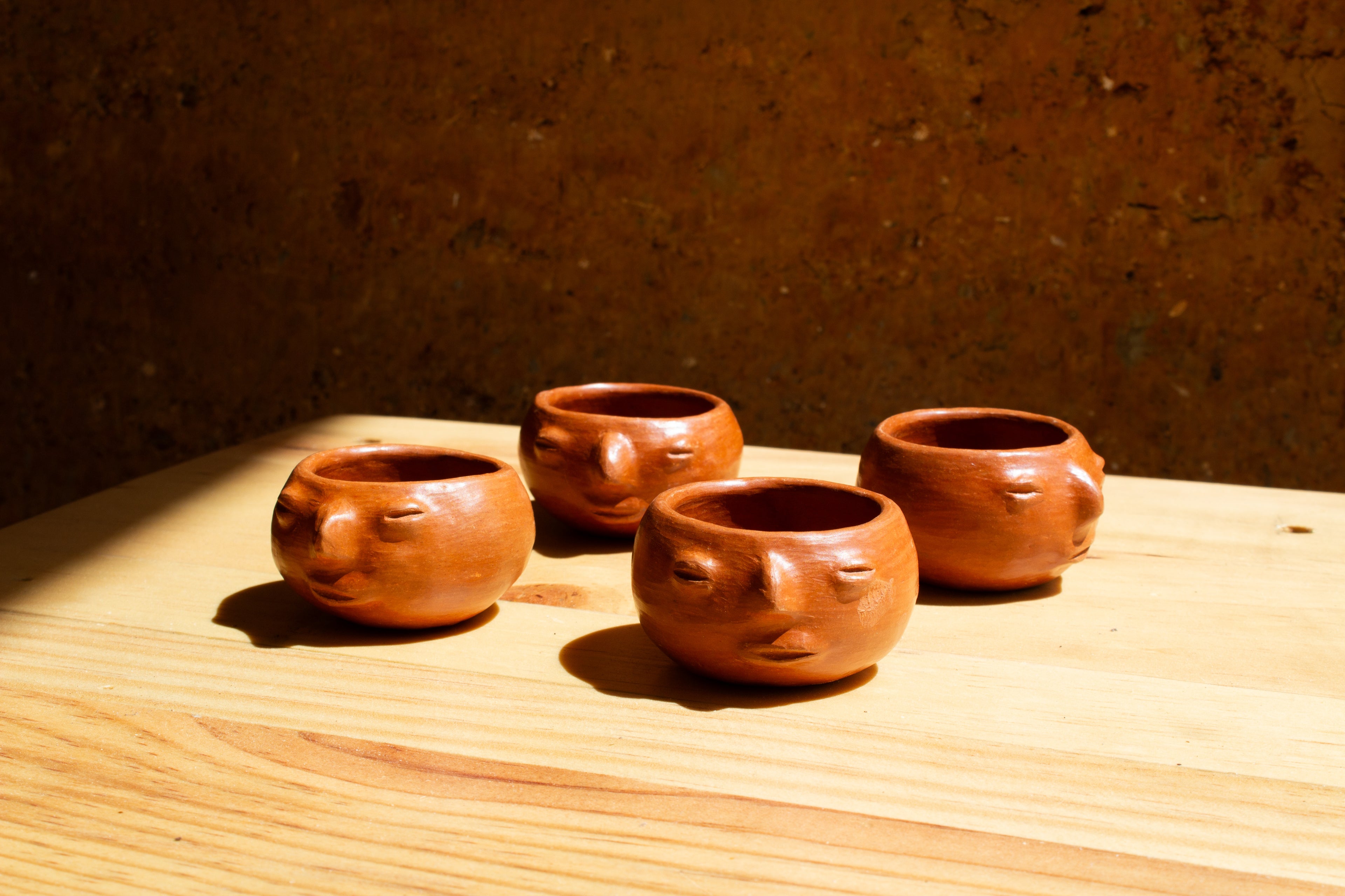 Juego de mezcaleros con cara de barro rojo