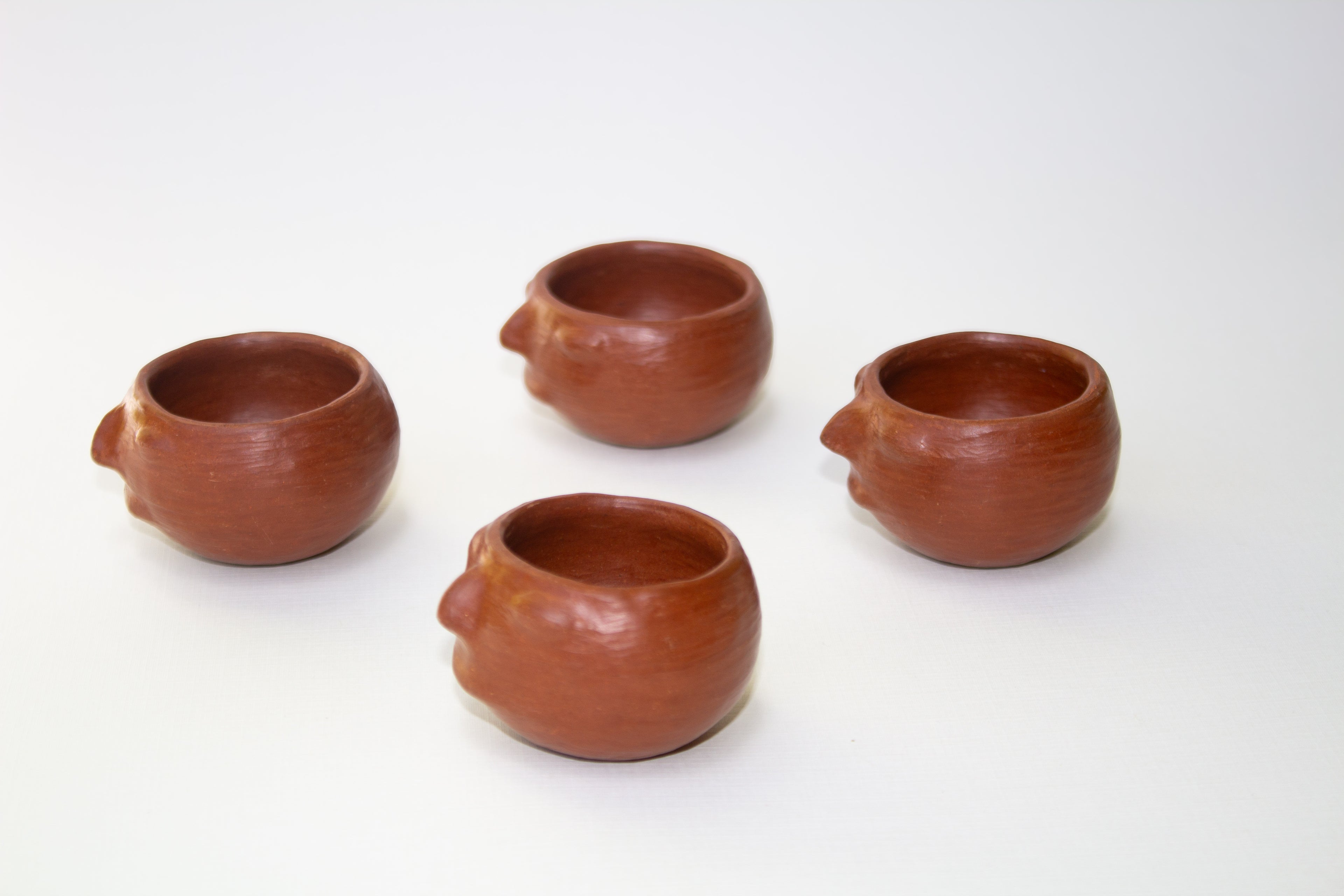 Juego de mezcalero con cara de barro rojo